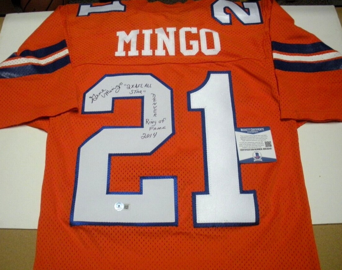 Gene Mingo Signed Denver Broncos Official Sand Knit Jersey with COA: Gene Mingo Signed Denver Broncos Official Sand Knit Jersey with COA This officially licensed Denver Broncos jersey, signed by Gene Mingo, is a must-have for any football fan. The jersey is made from d