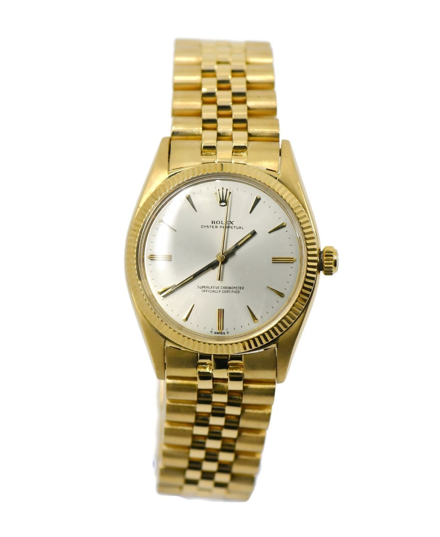 Rolex Oyster Perpetual 18K Yellow Gold Watch Ref 1013 with Box: Rolex Oyster Perpetual 18K Yellow Gold Watch Ref 1013 with Box Discover the elegance of the Rolex Oyster Perpetual, a stunning wristwatch crafted in 18K yellow gold. This pre-owned timepiece features 