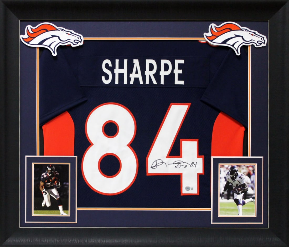 Shannon Sharpe Signed Navy Blue Jersey Framed Denver Broncos BAS Witnessed: Shannon Sharpe Signed Navy Blue Jersey Framed Denver Broncos BAS Witnessed This authentic navy blue pro style framed jersey has been personally signed by Shannon Sharpe, the legendary tight end of the