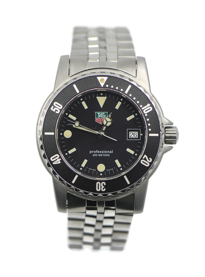 Men's TAG Heuer 1500 Quartz Stainless Steel Wristwatch WD1210 with Box: Men's TAG Heuer 1500 Quartz Stainless Steel Wristwatch WD1210 with Box This TAG Heuer 1500 Professional wristwatch features a stainless steel case and bracelet, complemented by a black bezel and black