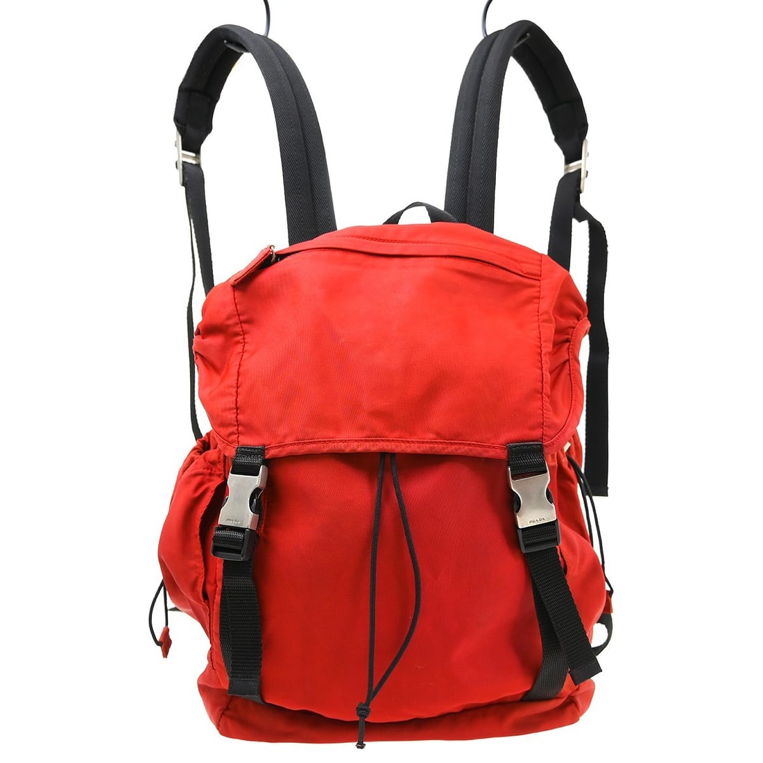 Prada Tessuto Red Nylon Double Buckle Unisex Backpack: Prada Tessuto Red Nylon Double Buckle Unisex Backpack This Prada Double Buckle Backpack features a striking red nylon exterior and a functional design suitable for both men and women. Crafted in Italy