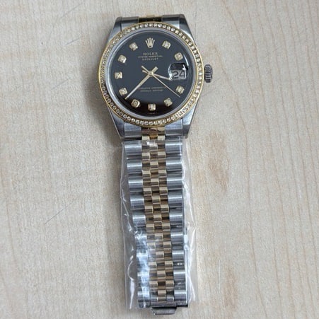 Datejust Ref 1601 Mens Watch With Aftermarket Black Diamond Dial: Datejust Ref 1601 Mens Watch With Aftermarket Black Diamond Dial This Rolex Datejust features an aftermarket black diamond dial and a pave plated diamond bezel, offering a striking appearance. Designe
