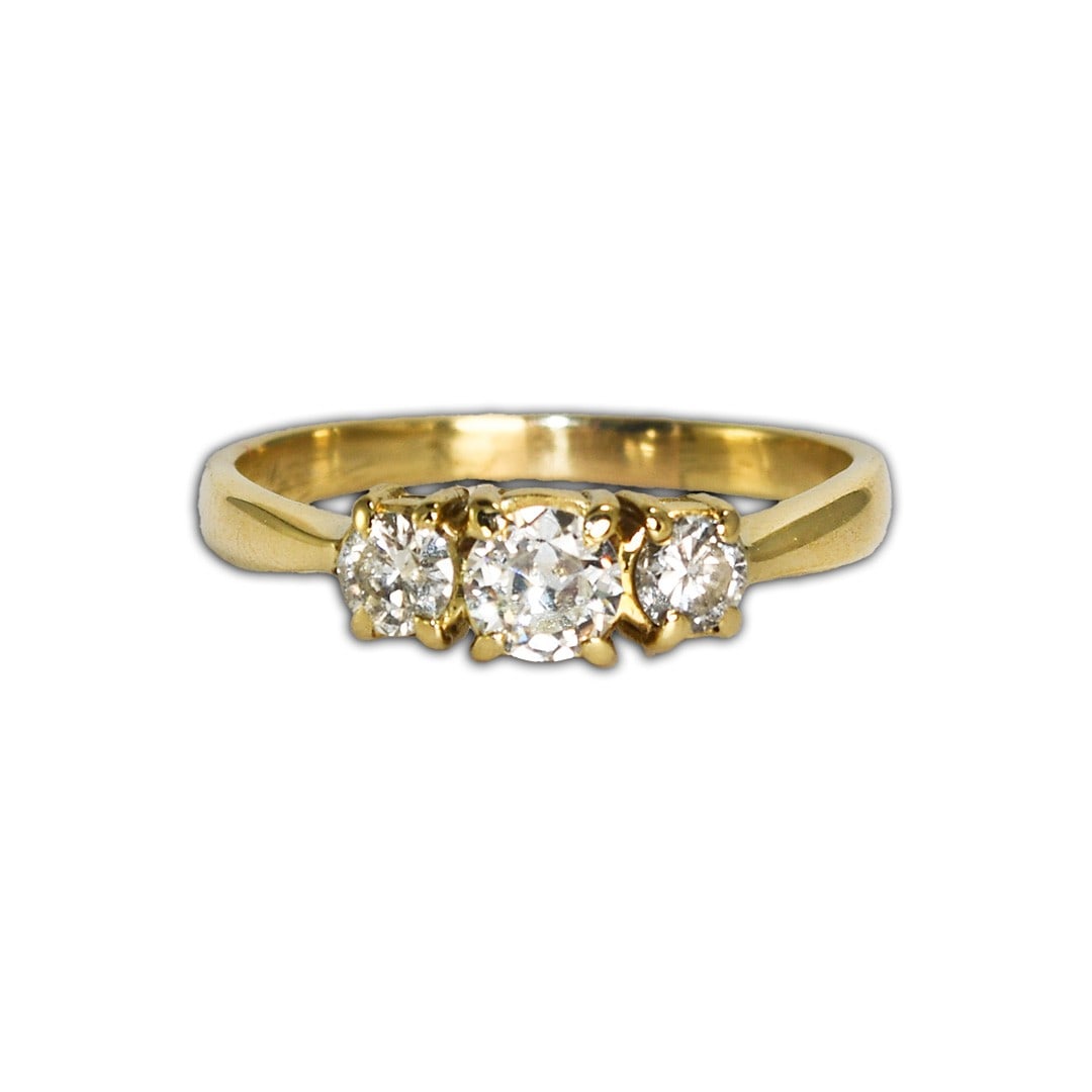 14K Yellow Gold 3 Diamond Three-Stone Ring Size 8: 14K Yellow Gold 3 Diamond Three-Stone Ring Size 8 This pre-owned three-stone diamond ring features a 14K yellow gold setting and a total of three diamonds. The center stone is a 0.30 carat transition 