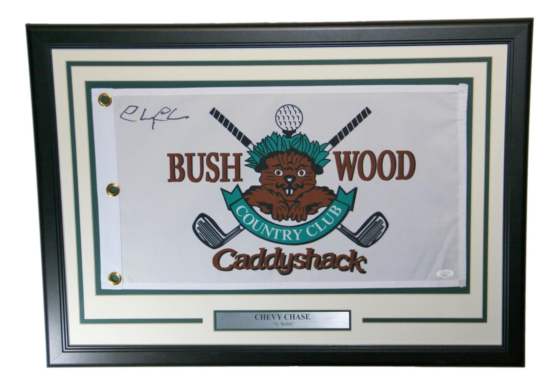 Chevy Chase Signed Caddyshack Golf Flag Framed JSA Authenticated: Chevy Chase Signed Caddyshack Golf Flag Framed JSA Authenticated Celebrate the iconic film 'Caddyshack' with this framed golf flag autographed by Chevy Chase. This original piece features a certified 