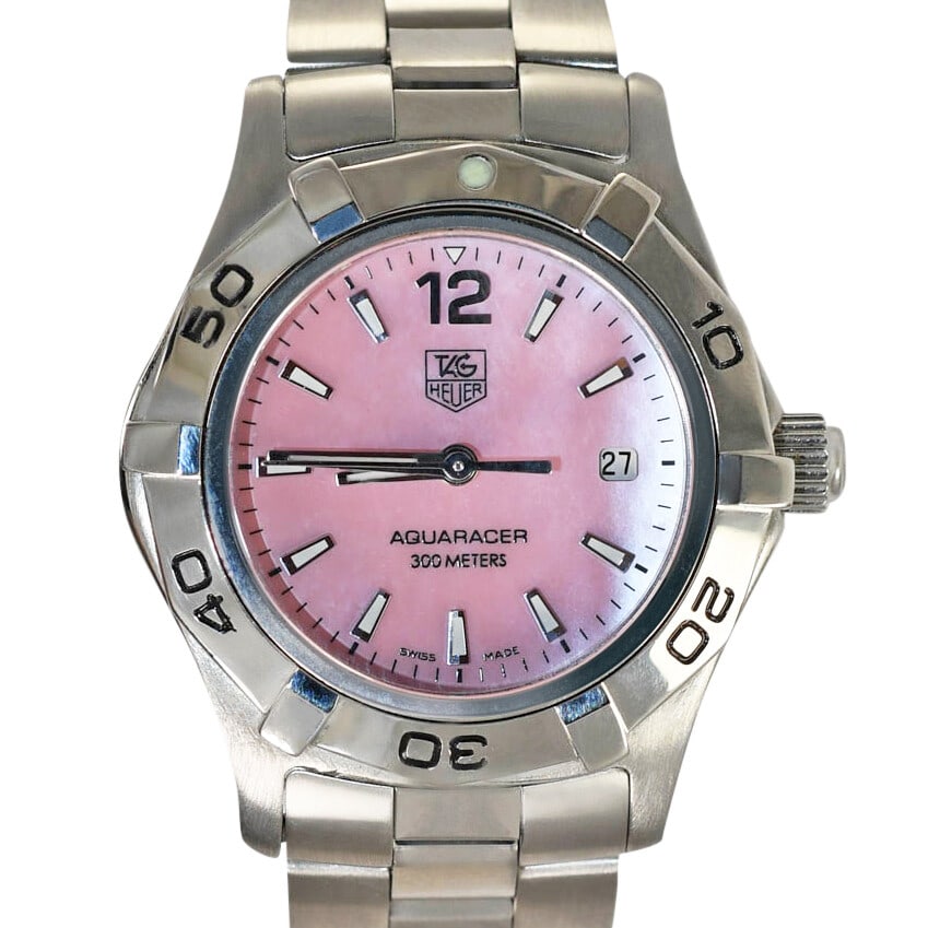 TAG Heuer AquaRacer Pink Mother of Pearl Quartz Wristwatch: TAG Heuer AquaRacer Pink Mother of Pearl Quartz Wristwatch This ladies' TAG Heuer AquaRacer wristwatch features a stainless steel band and a 27mm case. The watch is equipped with a quartz movement and