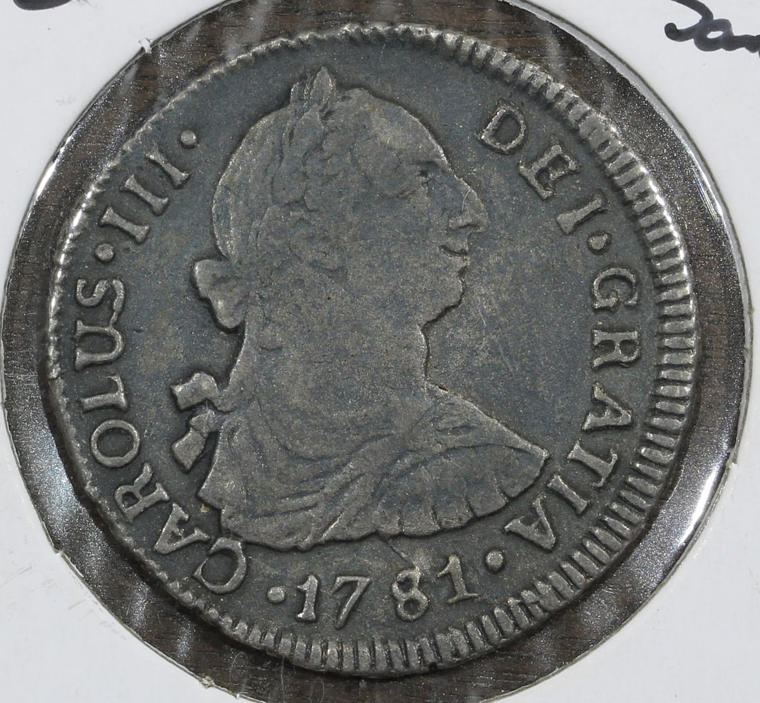 1781 Chile Silver 2 Reales Santiago Mint: 1781 Chile Silver 2 Reales Santiago Mint This 1781-So DA Chile Silver 2 Reales coin is a rare piece from the Santiago Mint. It is composed of silver with a fineness of 0.9 and has been circulated. The