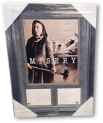 Framed Misery photo display with James Caan Kathy Bates signed cuts Beckett 21x29: Framed Misery photo display with James Caan Kathy Bates signed cuts Beckett 21x29 This framed display features autographed cuts from James Caan and Kathy Bates, accompanied by a photo from the film 'M