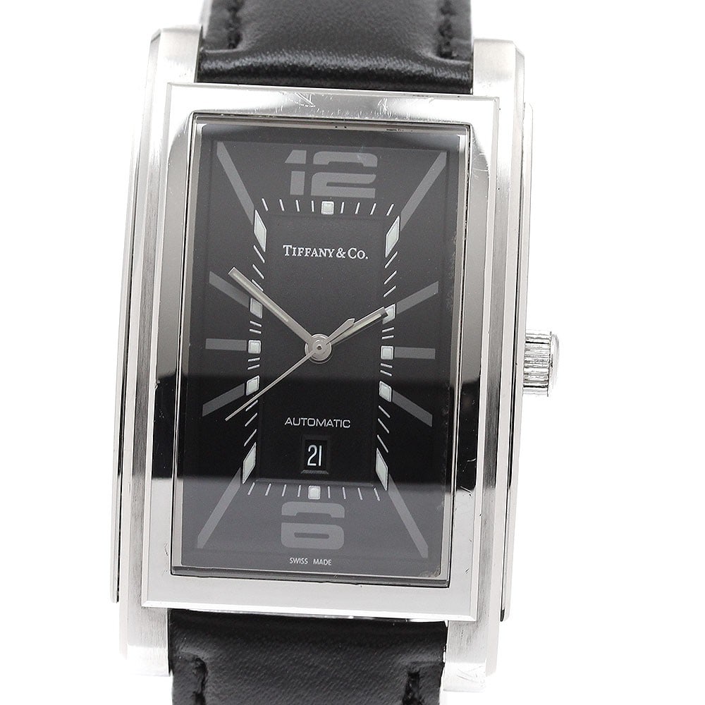 Tiffany Co Grand automatic date men's stainless steel wristwatch: Tiffany Co Grand automatic date men's stainless steel wristwatch This Tiffany & Co. Grand Date men's wristwatch features a stainless steel case with a black dial and automatic movement. The watch is e