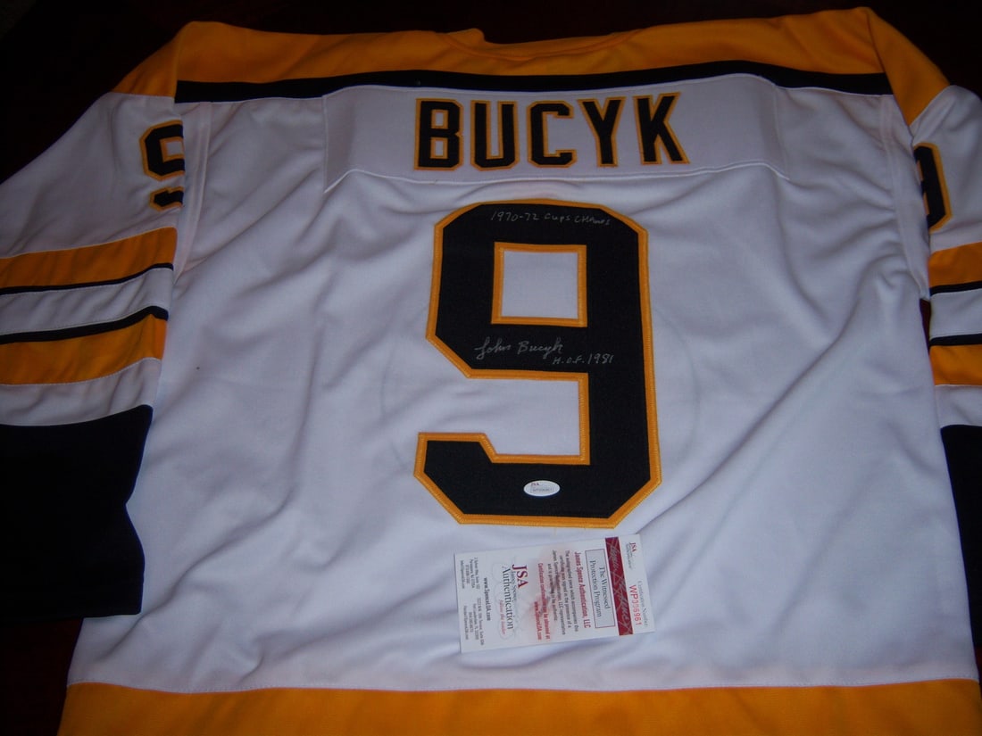 Signed Johnny Bucyk Jersey Boston Bruins Hall of Fame JSA COA: Signed Johnny Bucyk Jersey Boston Bruins Hall of Fame JSA COA This is a pre-owned Boston Bruins jersey signed by Johnny Bucyk. The jersey commemorates Bucyk's achievements, including his induction int