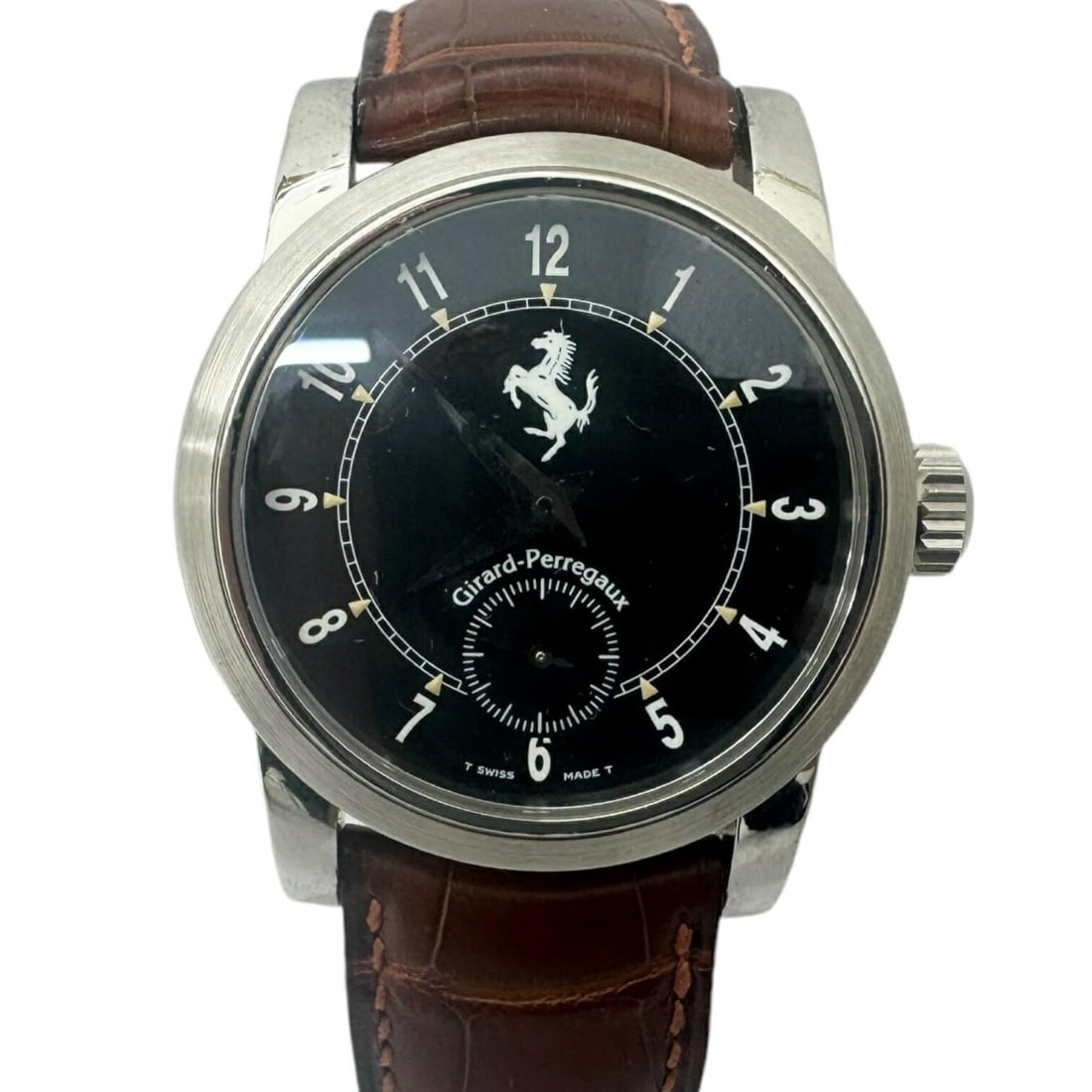 Girard Perregaux Ferrari 8030 Black Dial Leather Strap Watch: Girard Perregaux Ferrari 8030 Black Dial Leather Strap Watch This Girard Perregaux 8030 Ferrari men's wristwatch features a stainless steel case paired with a brown leather strap. The watch showcases 