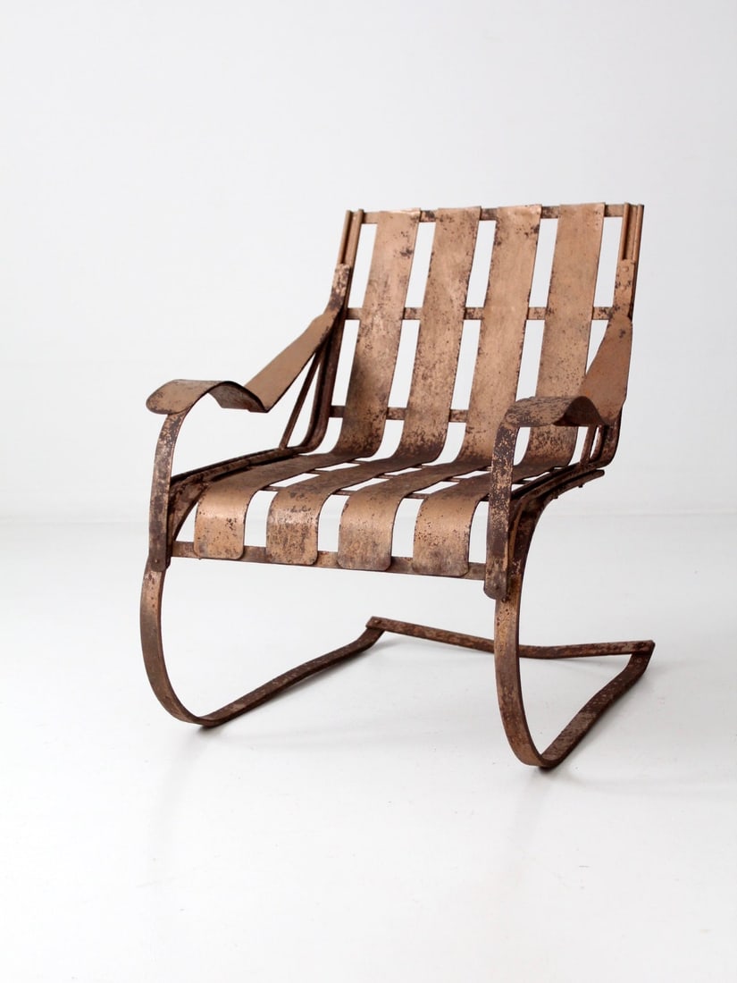 Vintage 1950s Patio Bouncer Chair Peachy-Bronze Metal: Vintage 1950s Patio Bouncer Chair Peachy-Bronze Metal Embrace vintage charm with this 1950s patio bouncer chair, a classic piece that features a sturdy metal lawn chair design with distinctive slat ba