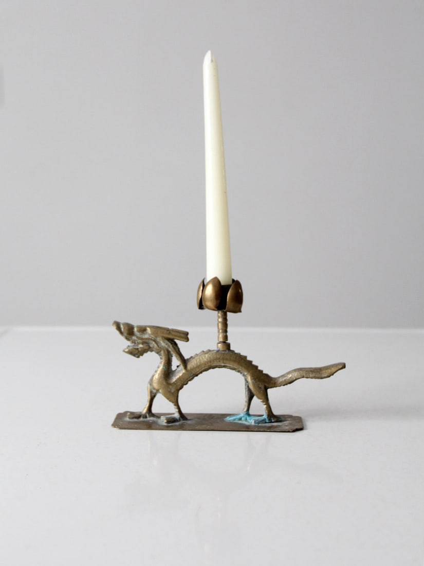 Vintage Chinese Brass Dragon Candle Holder with Lotus Design: Vintage Chinese Brass Dragon Candle Holder with Lotus Design This vintage Chinese brass candle holder features an intricate design shaped like a dragon entwined with lotus flowers. It is designed to h