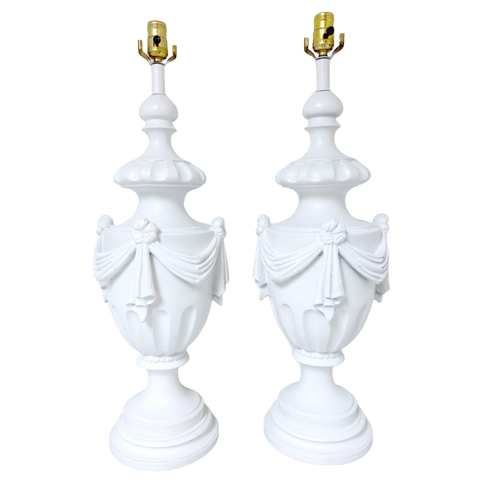 Vintage Hollywood Regency White Lacquered Urn Lamps Set of 2: Vintage Hollywood Regency White Lacquered Urn Lamps Set of 2 Enhance your living space with this exquisite pair of Large Hollywood Regency Neoclassical White Lacquered Draped Urn Lamps from the 1950s.
