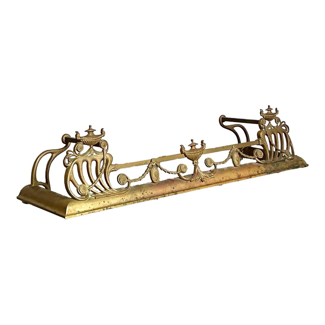 Vintage Hollywood Regency Brass Fireplace Fender 53.25" Wide: Vintage Hollywood Regency Brass Fireplace Fender 53.25" Wide Enhance the elegance of your hearth with this exquisite vintage Hollywood Regency style fireplace fender. Crafted from warm brass, it featu