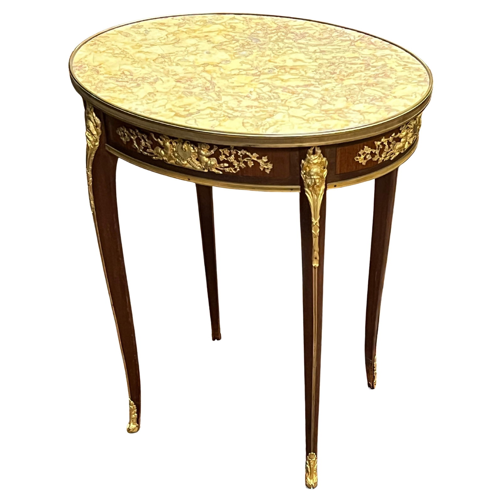 Oval French Side Table with Gilt Bronze Mounts and Marble Top c1890: Oval French Side Table with Gilt Bronze Mounts and Marble Top c1890 This exceptional late 19th century French side table features an oval shape in the Louis XV / XVI style. It is crafted with mahogany
