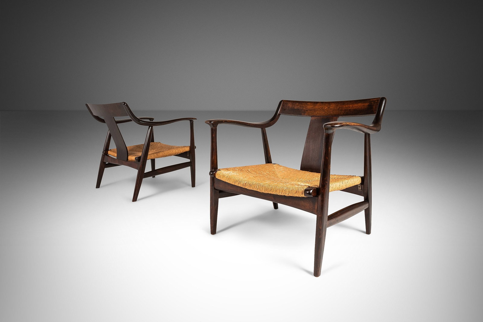 1960s Japan Set of 2 Mid Century Modern Lounge Chairs with Rush Seats: 1960s Japan Set of 2 Mid Century Modern Lounge Chairs with Rush Seats This exquisite set of two Mid Century Modern low profile lounge chairs features an alluring design, originally sold by the Takumi 
