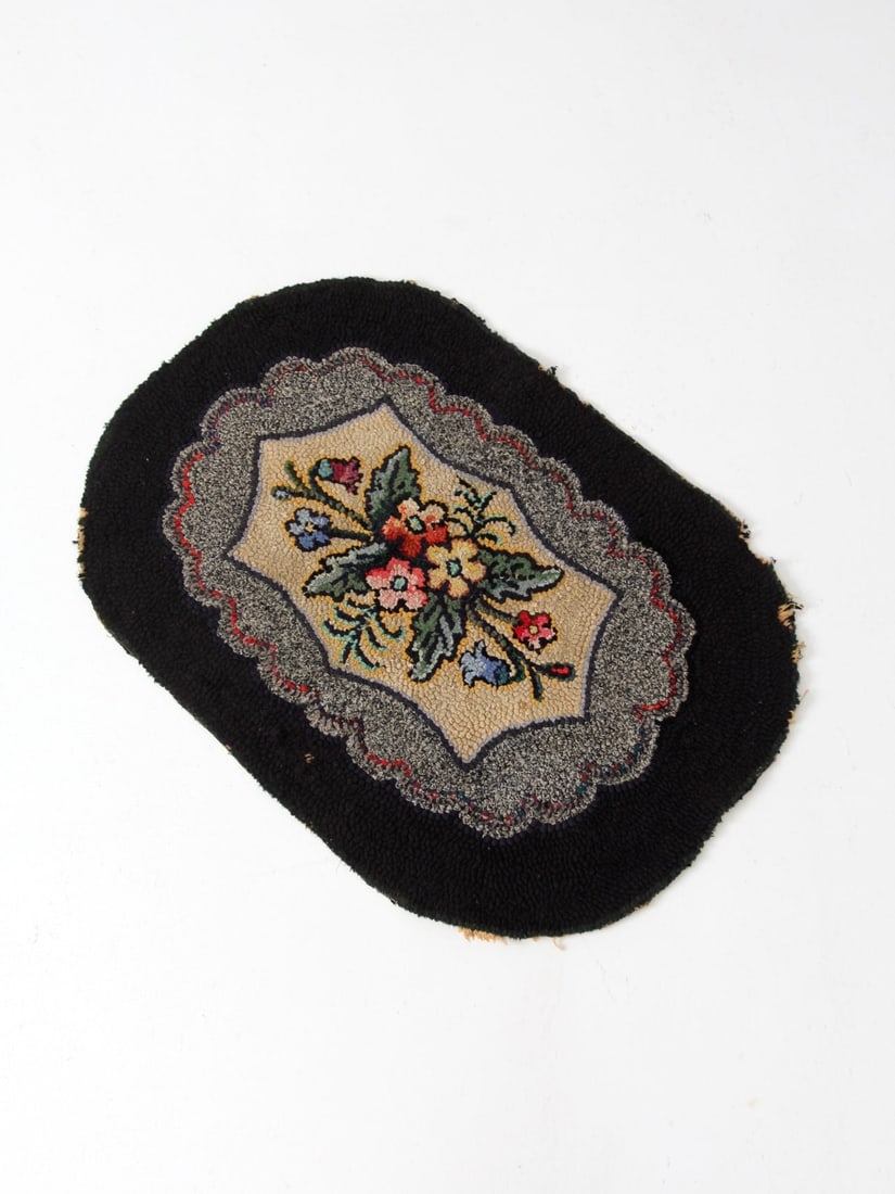 34 x 23 Inch Antique Hooked Rug with Floral Motif and Scalloped Edges: 34 x 23 Inch Antique Hooked Rug with Floral Motif and Scalloped Edges This antique hooked accent rug features a floral medallion design with scalloped borders in cream, grey, and black. Its hand-worke