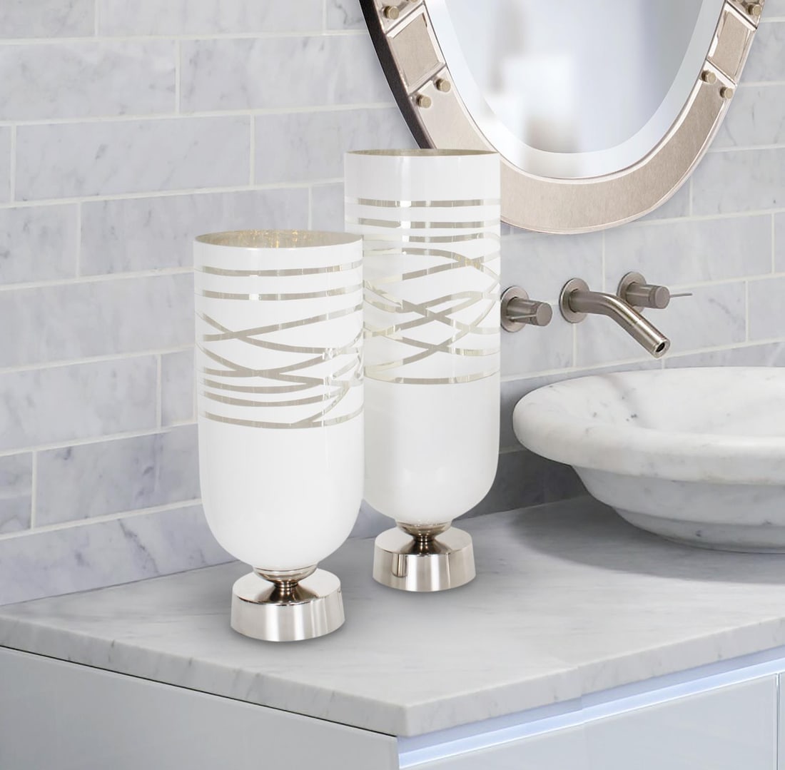 Howard Elliott Lustig Glossy White Aluminum Vessel 14H 6W 6D: Howard Elliott Lustig Glossy White Aluminum Vessel 14H 6W 6D Introducing the Stylish Lustig Vessel, a perfect addition to modern spaces. This vessel features a sleek round shape and a striking glossy 