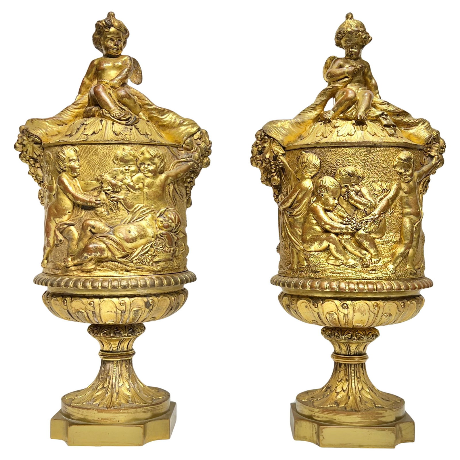 Set of Two Neoclassical Gilt Bronze Urns Inspired by Clodion 19th Century: Set of Two Neoclassical Gilt Bronze Urns Inspired by Clodion 19th Century This pair of antique 19th-century gilt bronze urns is crafted in the neoclassical revival style, inspired by the French Louis 
