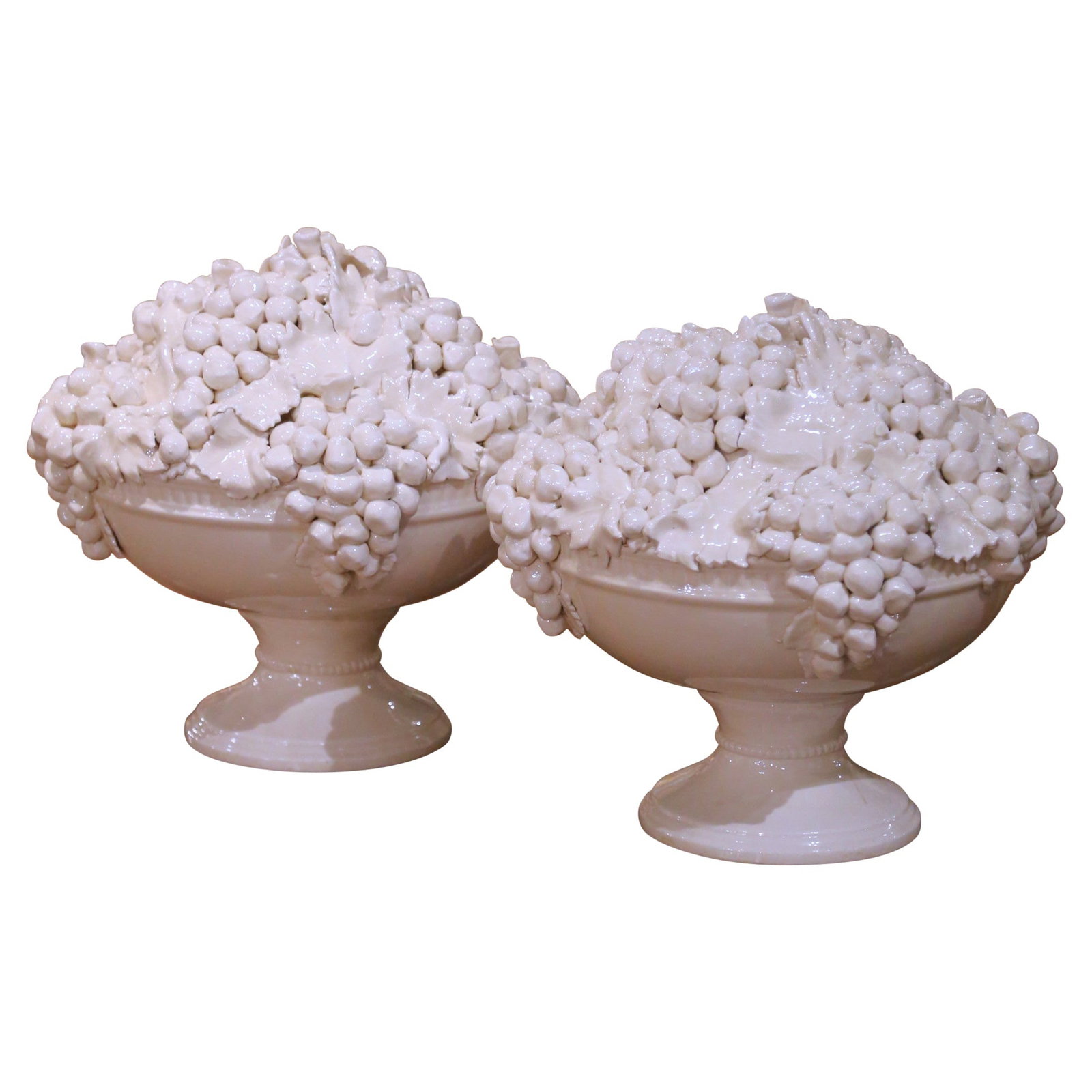 Set of Two Italian Creamware Grape Motif Pedestal Compotes Mid-Century: Set of Two Italian Creamware Grape Motif Pedestal Compotes Mid-Century This pair of mid-century Italian creamware compotes features intricately hand-carved and hand-painted grape clusters and vine lea