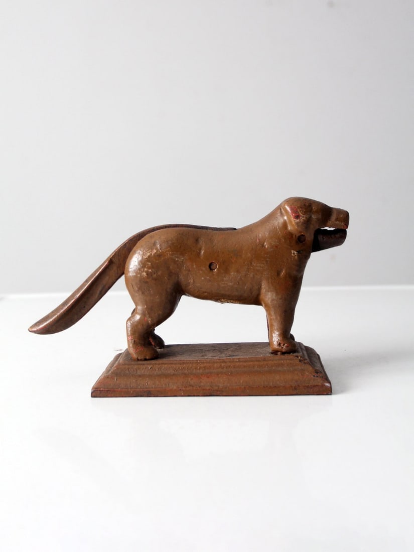 Antique Dog Shaped Cast Iron Nutcracker Early 20th Century: Antique Dog Shaped Cast Iron Nutcracker Early 20th Century This charming antique painted cast iron nutcracker, dating back to the early 20th century, is designed in the shape of a dog. To use, simply 