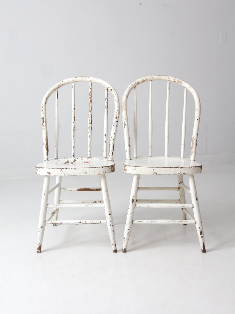 Pair Antique Windsor Dining Chairs Spindle Back Aged White Paint: Pair Antique Windsor Dining Chairs Spindle Back Aged White Paint This pair of antique Windsor dining chairs features classic spindle backs and gracefully bowed shaping, enhanced by an aged white paint