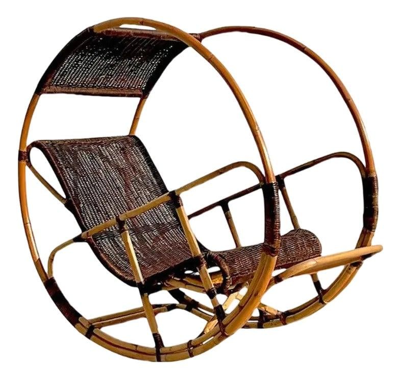 Vintage Coastal Italian Rattan Rocking Chair After Franco Bettonica: Vintage Coastal Italian Rattan Rocking Chair After Franco Bettonica This stunning vintage Coastal Italian rocking chair is wrapped in rattan and inspired by the iconic "Donaoldo" design by Franco Bett