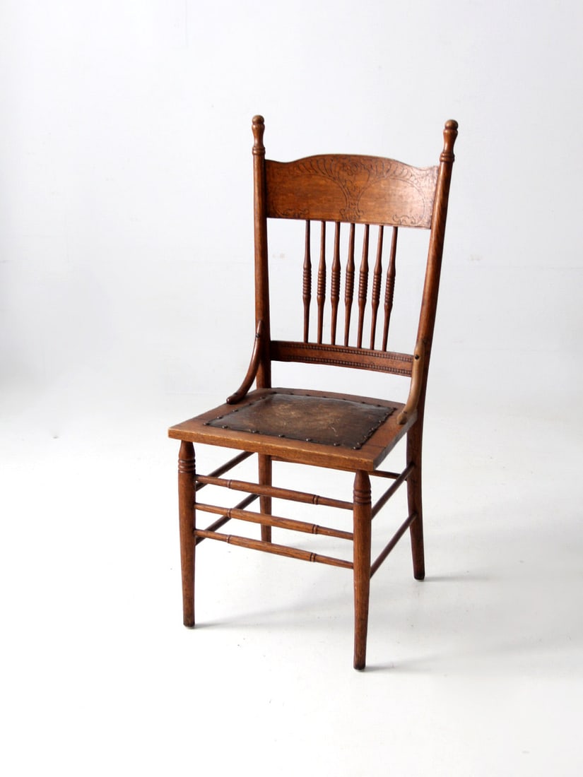 Victorian Antique Pressed Back Chair with Leather Seat: Victorian Antique Pressed Back Chair with Leather Seat This antique pressed back side chair, dating back to the late 19th century, showcases a stunning tall wooden back with a distinctive "press" back