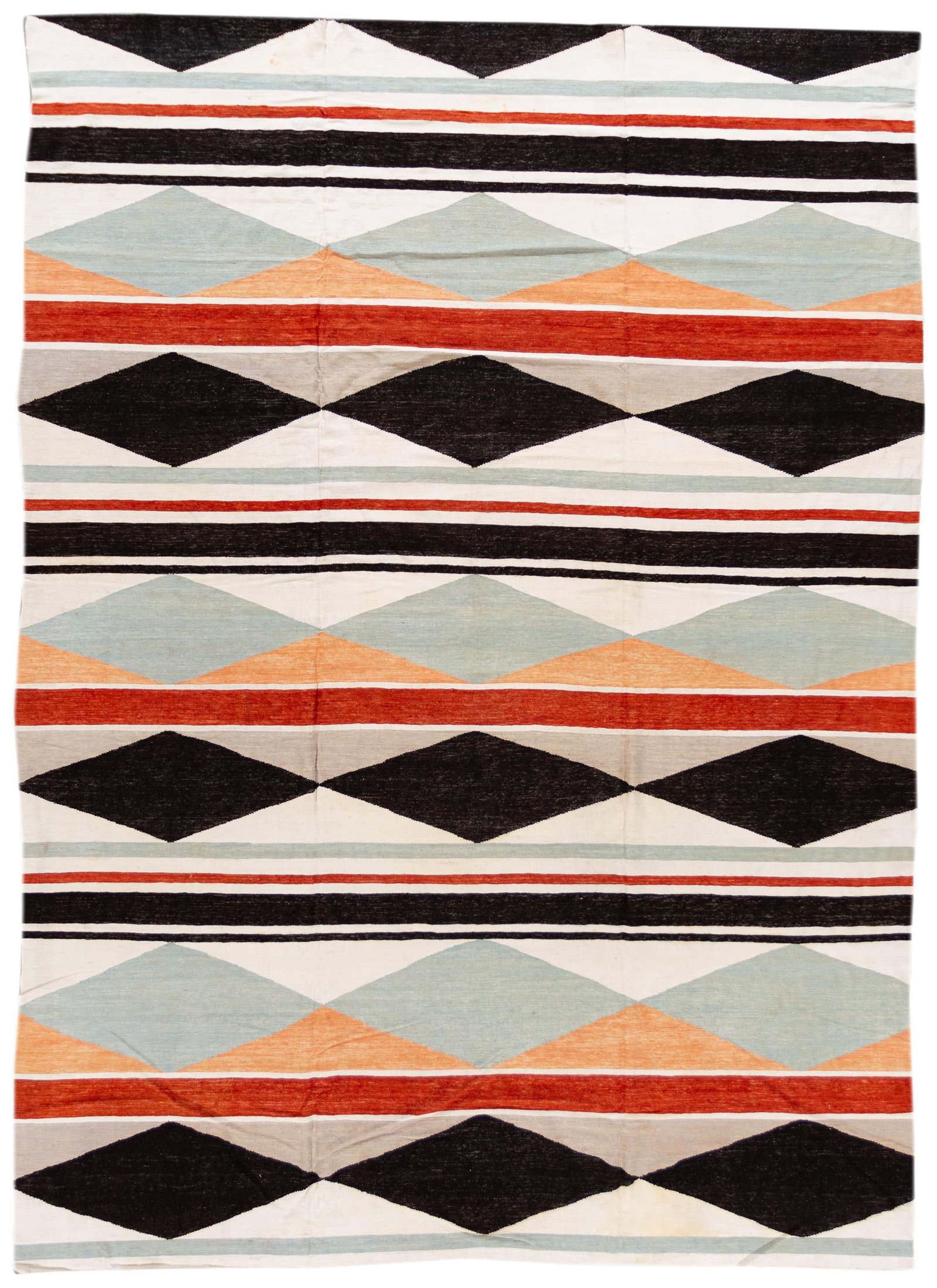 Hand-Knotted Wool Kilim Rug 10'0" x 13'9" Multi-Color Geometric Design: Hand-Knotted Wool Kilim Rug 10'0" x 13'9" Multi-Color Geometric Design Enhance your space with this exquisite 21st Century Modern Kilim Rug, featuring a stunning hand-knotted design. The rug showcases