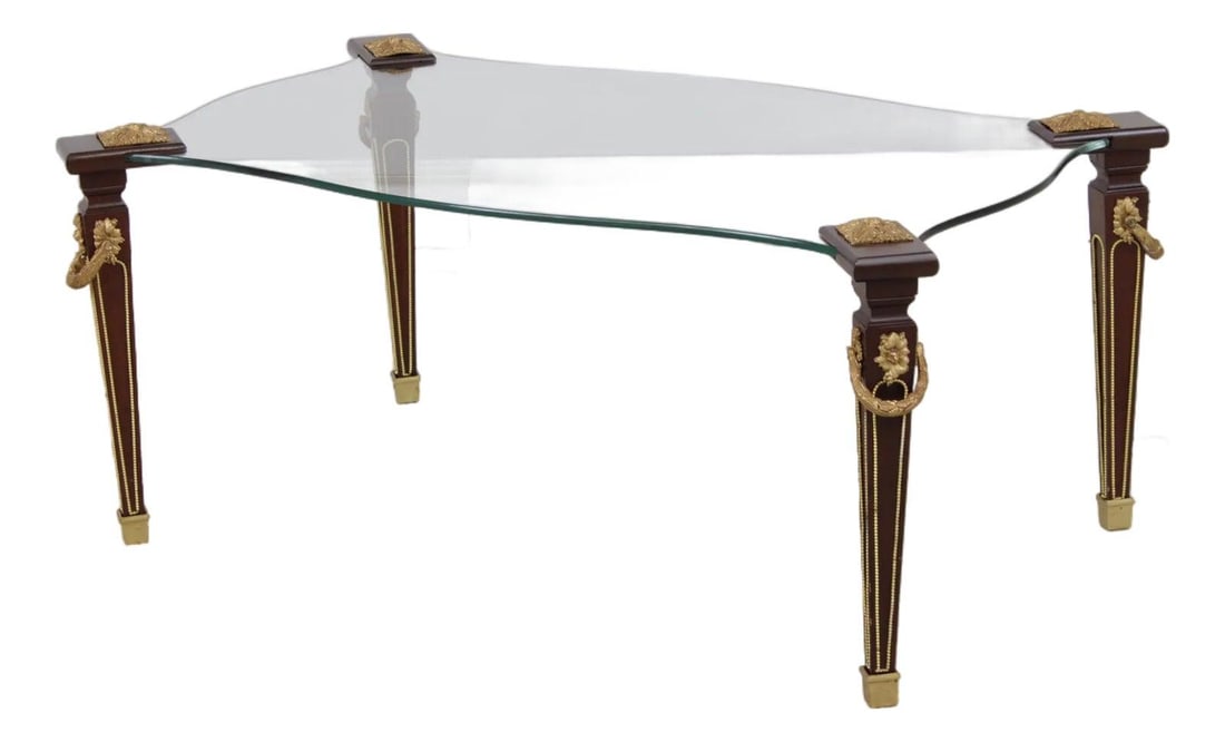 French Style Mahogany Glass Coffee Table With Bronze Mounts and Brass Capped Feet: French Style Mahogany Glass Coffee Table With Bronze Mounts and Brass Capped Feet This vintage Louis XVI style coffee and cocktail table features a glass top set within a finely carved mahogany frame.