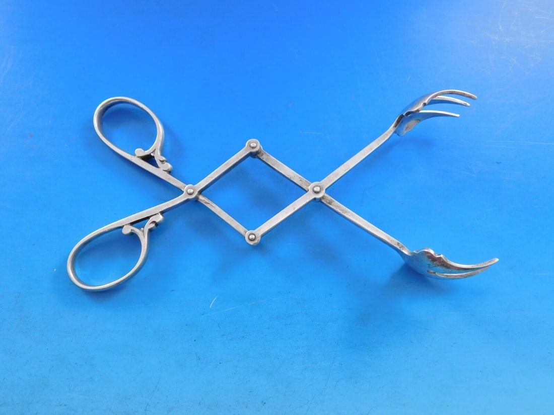 Lebkuecher & Co Number 2232-1 Sterling Silver Mechanical Ice Tongs 7 1/2 in: Lebkuecher & Co Number 2232-1 Sterling Silver Mechanical Ice Tongs 7 1/2 in Discover the elegance of the Number 2232-1 mechanical ice tongs by Lebkuecher & Co. Crafted from high-quality sterling silve