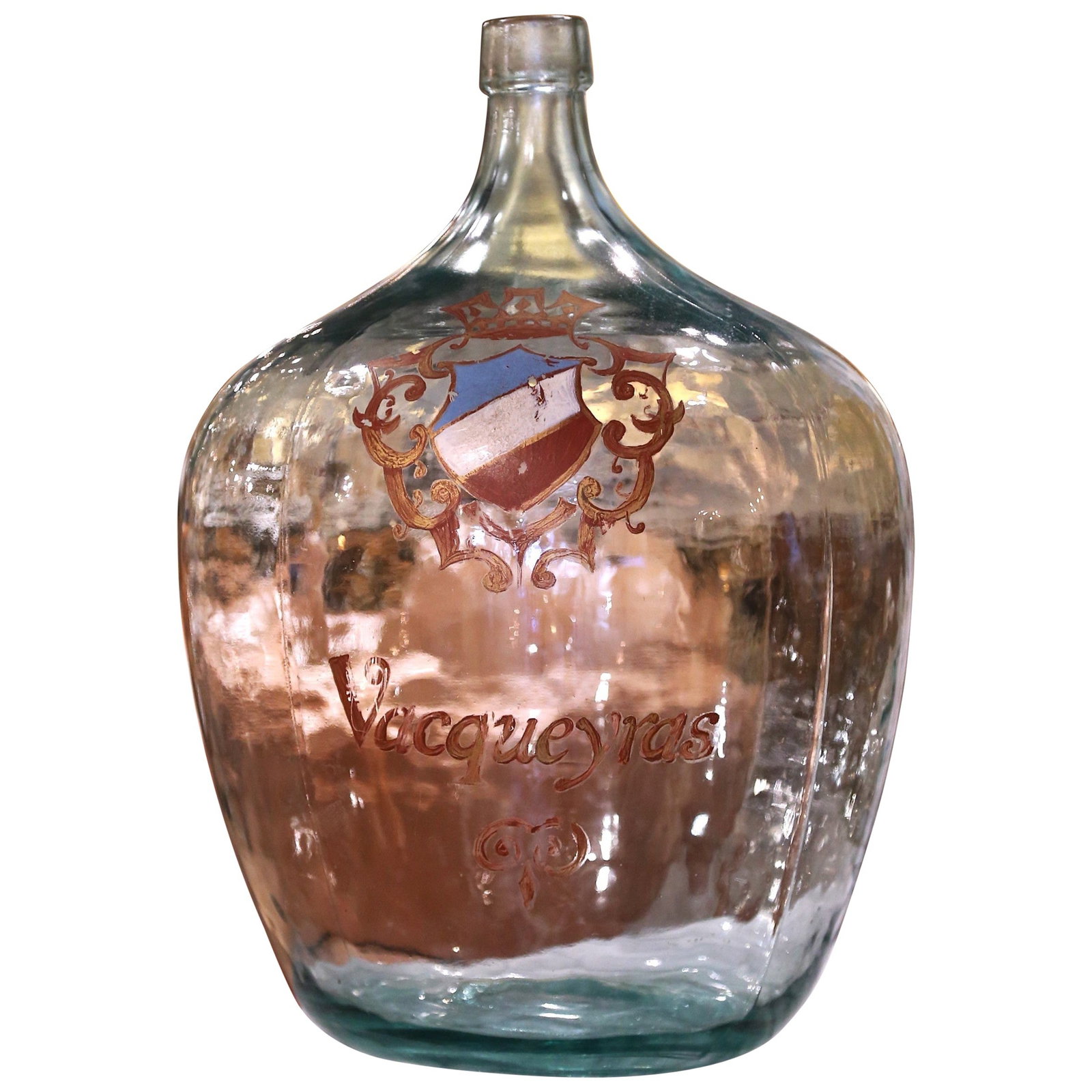 Hand Blown French Demijohn Glass Bottle with Vacqueyras Crest 20in: Hand Blown French Demijohn Glass Bottle with Vacqueyras Crest 20in This exquisite French hand blown demijohn glass bottle showcases a stunning gilt family crest inscribed with the word "Vacqueyras". C