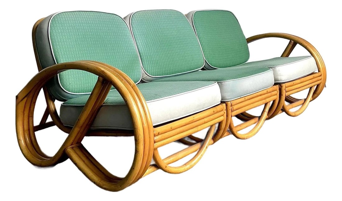 Mid-Century Rattan Three-Seat Sofa by Beverly Hills Rattan 1950s: Mid-Century Rattan Three-Seat Sofa by Beverly Hills Rattan 1950s This vintage 1950s sofa by Beverly Hills Rattan exemplifies tropical modernism with its multi-strand bent rattan armrests and rhythmic 