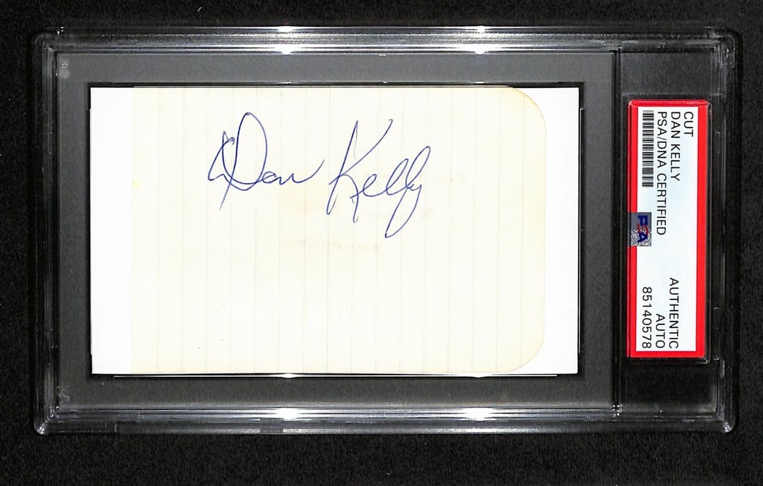 Dan Kelly Signed 3x5 Cut Card PSA/DNA New York Jets: Dan Kelly Signed 3x5 Cut Card PSA/DNA New York Jets This original autographed 3x5 cut card features the signature of Dan Kelly, a notable player in NFL history. The card is encapsulated in a tamper-pr