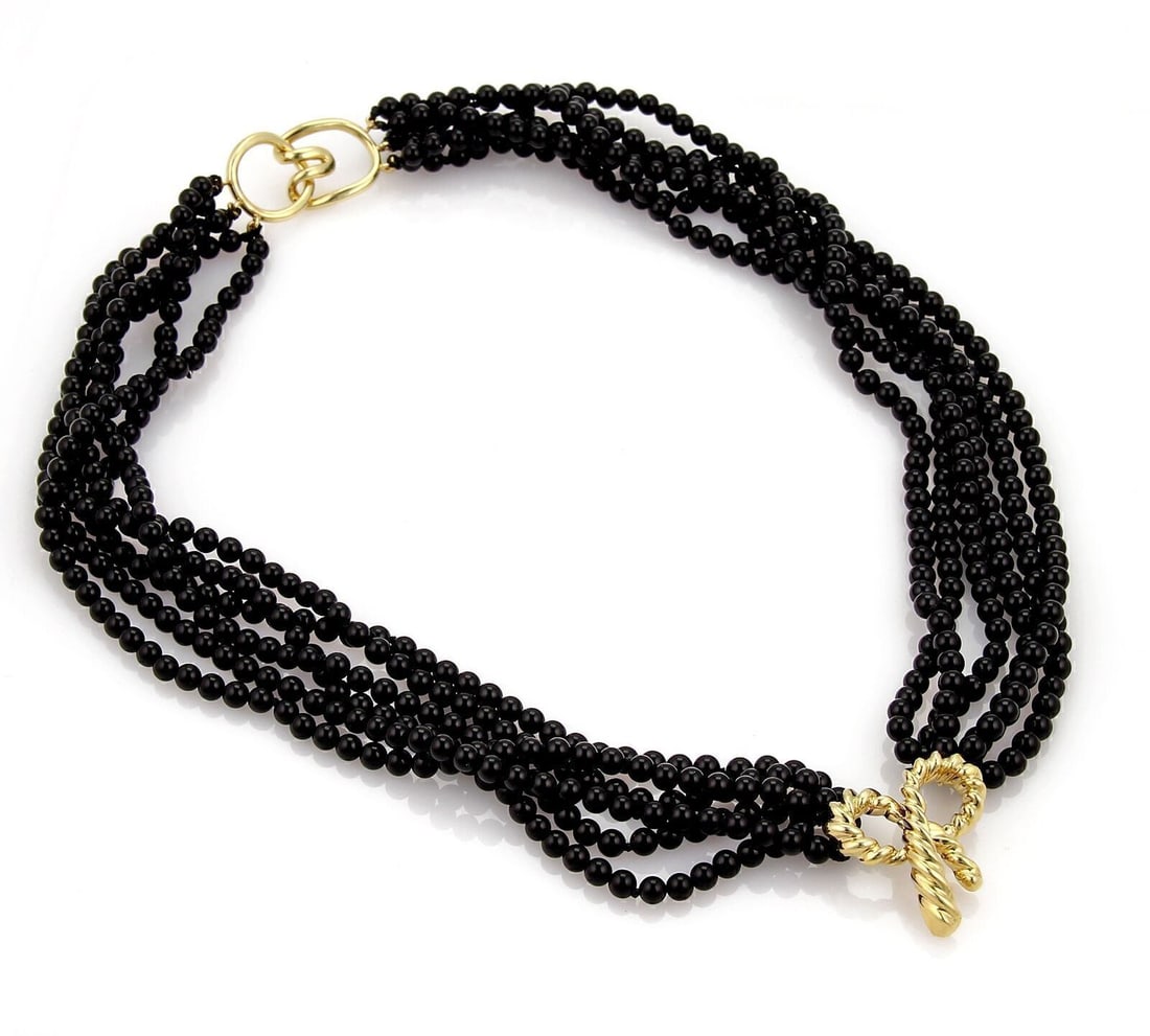 Tiffany & Co. bow pendant onyx bead necklace 18k yellow gold: Tiffany & Co. bow pendant onyx bead necklace 18k yellow gold This authentic vintage Tiffany & Co. necklace features multiple strands of glossy black onyx beads, highlighted by a sculptural bow pendant