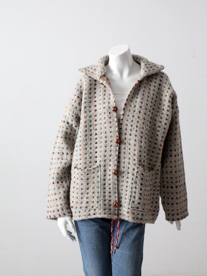 Vintage Boho Woven Knit Jacket with Rainbow Pattern: Vintage Boho Woven Knit Jacket with Rainbow Pattern Embrace a laid-back bohemian style with this vintage woven knit hippie jacket. Crafted in a soft gray weave, this jacket features a vibrant rainbow 
