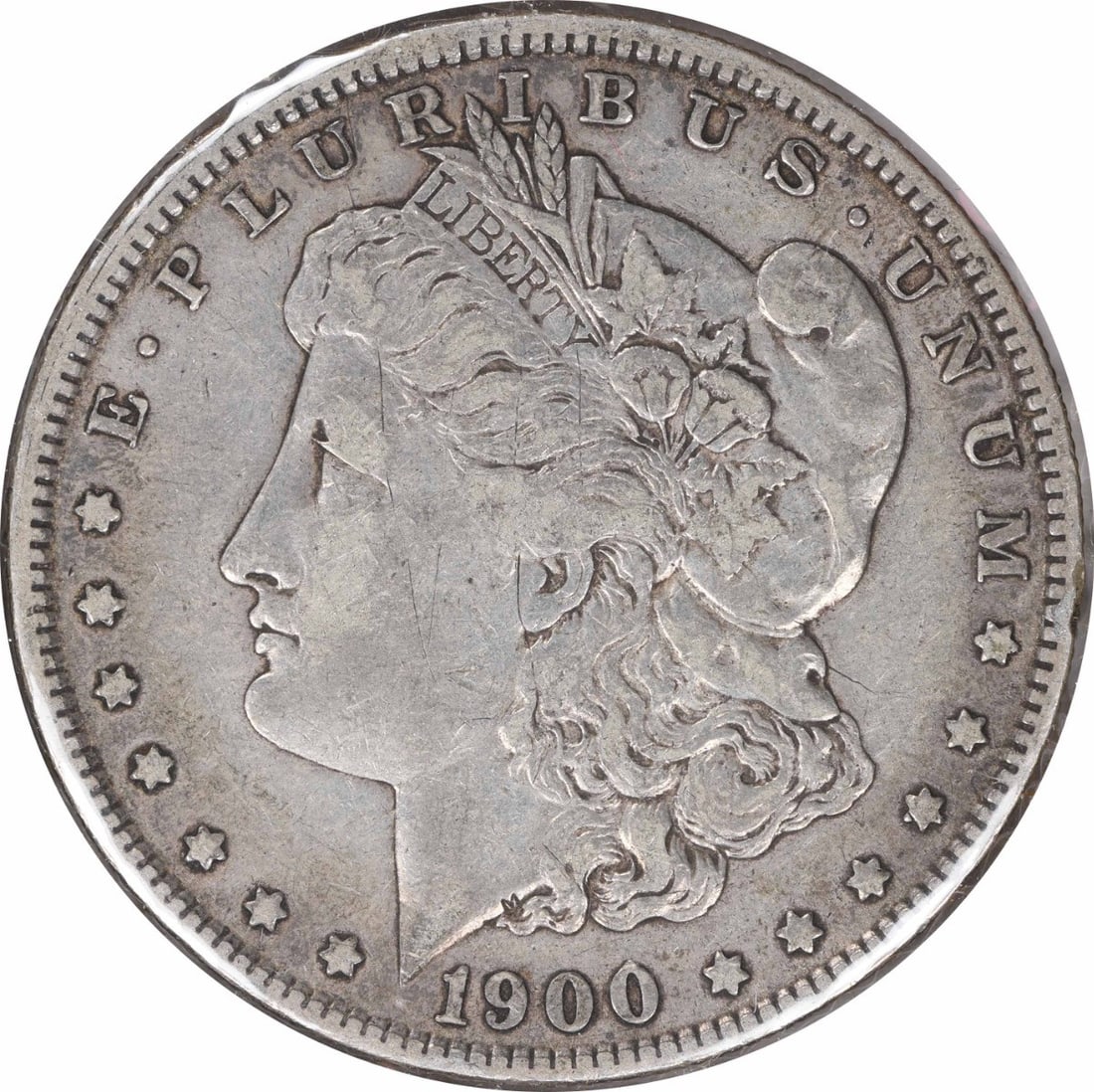1900-O Morgan Silver Dollar Uncertified VF 90% Silver Coin: 1900-O Morgan Silver Dollar Uncertified VF 90% Silver Coin This 1900-O/CC Morgan Silver Dollar is a remarkable piece of numismatic history, featuring a design by George T. Morgan. The coin is in Very 