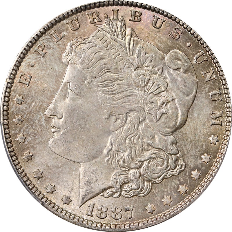 1887-P Morgan Dollar PCGS MS63 Obverse Toning: 1887-P Morgan Dollar PCGS MS63 Obverse Toning This 1887-P Morgan Silver Dollar is graded MS63 by PCGS and features attractive obverse toning. Struck in 0.9 fine silver, this uncirculated coin was mint