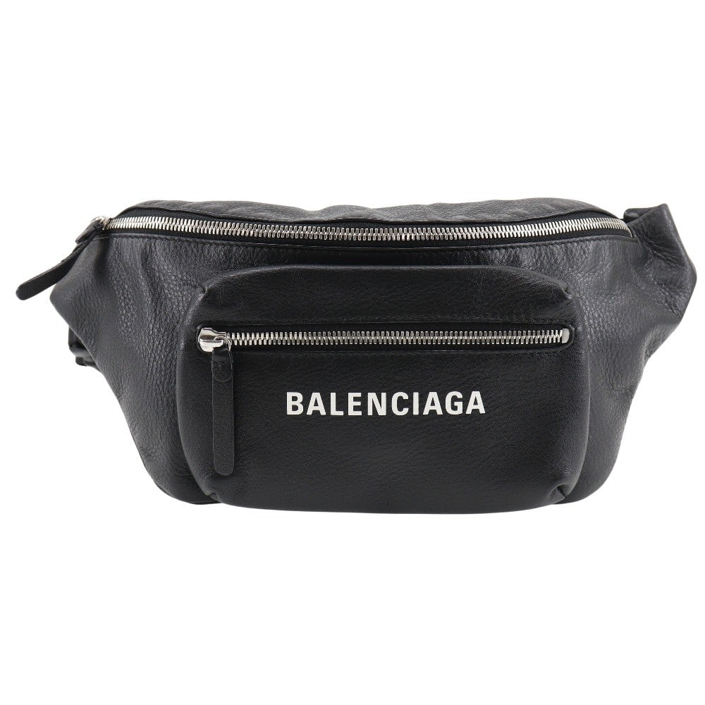 Black Leather Everyday Waist Bag by Balenciaga: Black Leather Everyday Waist Bag by Balenciaga This Balenciaga Everyday Waist Bag is crafted from black leather and designed for unisex use. Made in Italy, it features a sleek silhouette and practical