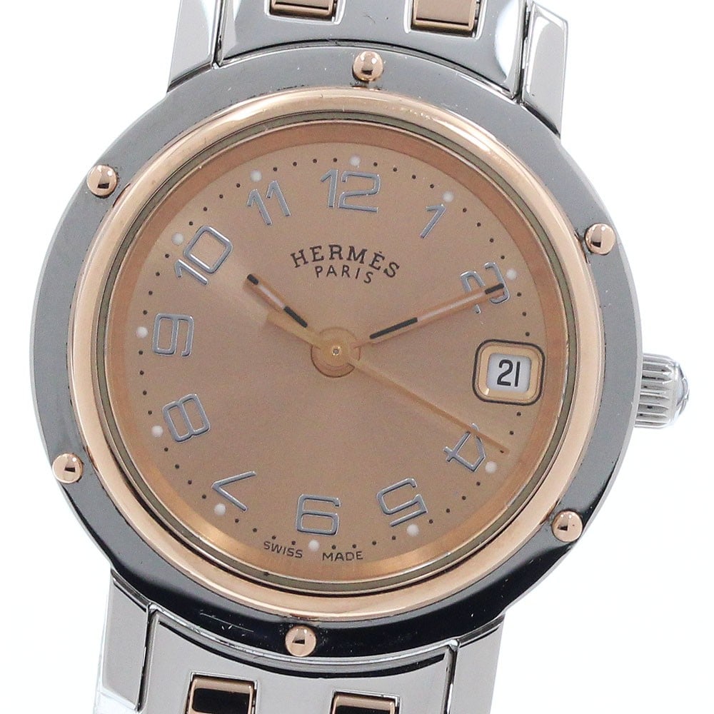 Hermes Clipper Nakule Quartz Date Womens Wristwatch: Hermes Clipper Nakule Quartz Date Womens Wristwatch This pre-owned HERMES Clipper Nakule Date Quartz women's wristwatch features a stainless steel and gold-plated case and bracelet with an orange dial