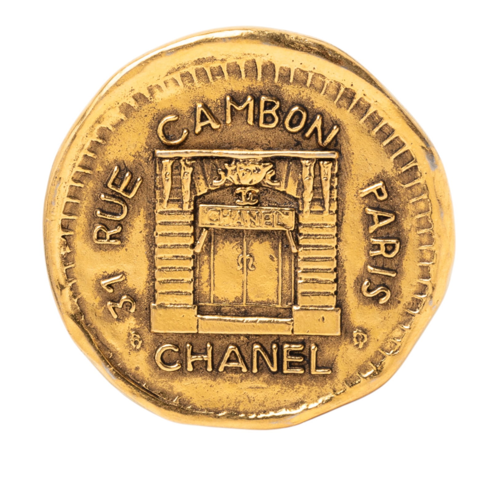 Chanel 31 Rue Cambon Coin Brooch Gold Plated Metal Pin: Chanel 31 Rue Cambon Coin Brooch Gold Plated Metal Pin This Chanel brooch features a gold-plated metal body designed in the style of a coin and is secured with a pin back closure. Made in France, it i