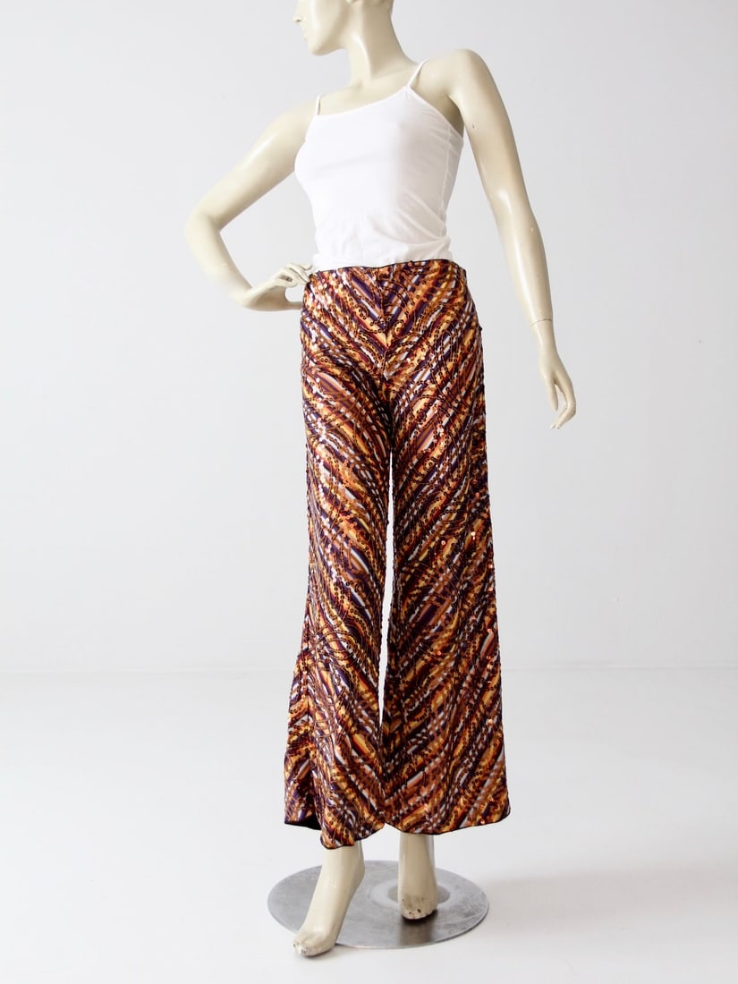 Vintage Missoni Ankle Length Pants with Sequins: Vintage Missoni Ankle Length Pants with Sequins Discover a unique addition to your wardrobe with these vintage Missoni pants, crafted from a soft rayon knit. Featuring a stunning array of vibrant stri