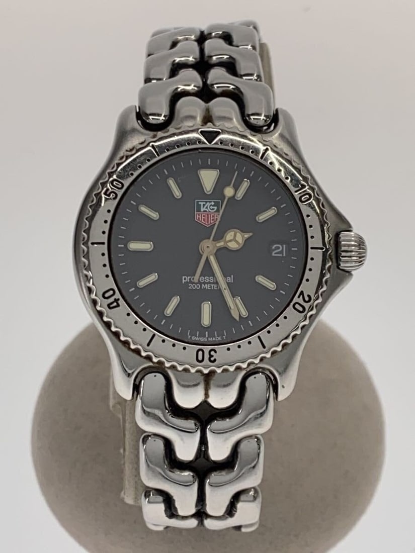 TAG Heuer S le Quartz Stainless Steel Wristwatch for Men: TAG Heuer S le Quartz Stainless Steel Wristwatch for Men This TAG Heuer S/el Professional Quartz S99.213 men's wristwatch features a black dial and a stainless steel case and band. Designed for men, t