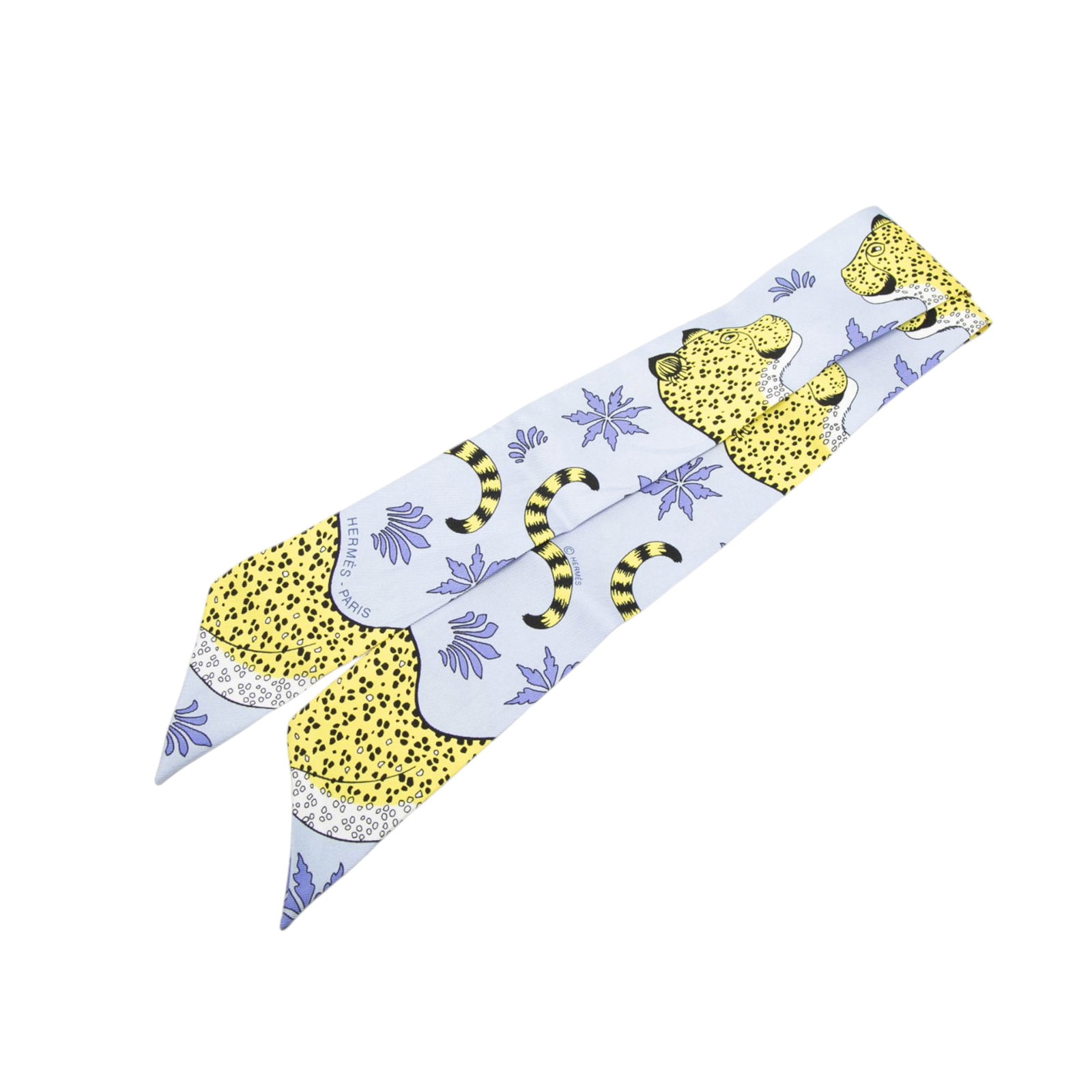 Hermes Blue Les Leopards Silk Twilly: Hermes Blue Les Leopards Silk Twilly This Hermes Les Leopards Twilly scarf is crafted from 100% silk and features a distinctive leopard print design in blue. Made in France, it is a stylish accessory 