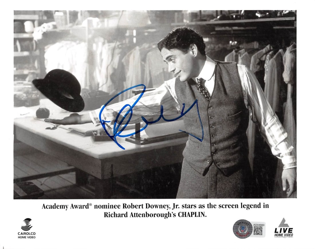 Robert Downey Jr. Signed Chaplin 8x10 Photo with Beckett COA: Robert Downey Jr. Signed Chaplin 8x10 Photo with Beckett COA This authentic black and white photograph features Robert Downey Jr. as he portrays Charlie Chaplin, personally signed by the actor himself