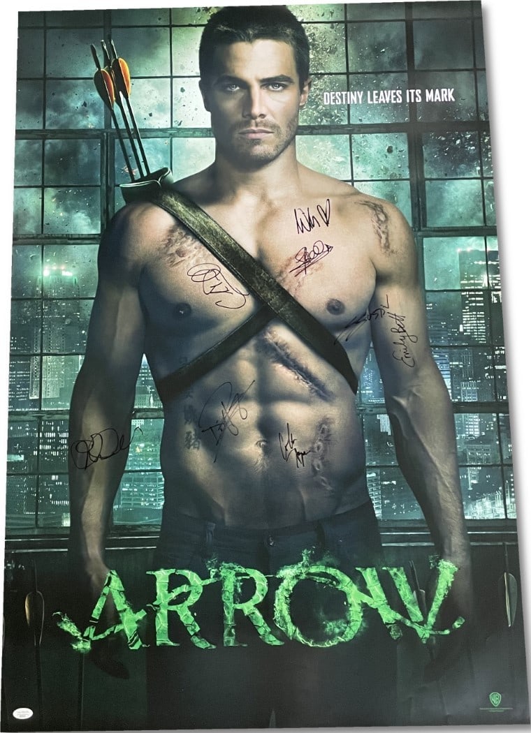 Arrow Cast Autographed 27x40 WB Poster Signed by Amell Holland Hayes JSA Certified: Arrow Cast Autographed 27x40 WB Poster Signed by Amell Holland Hayes JSA Certified This is an original 27x40 poster from the iconic series Arrow, beautifully autographed by cast members Stephen Amell,