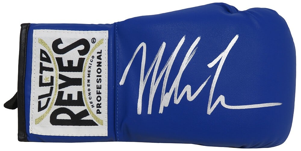 Mike Tyson Signed Cleto Reyes Blue Boxing Glove with COA: Mike Tyson Signed Cleto Reyes Blue Boxing Glove with COA This is a Mike Tyson signed Cleto Reyes blue boxing glove, a remarkable collectible for boxing enthusiasts. The glove features Tyson's authenti