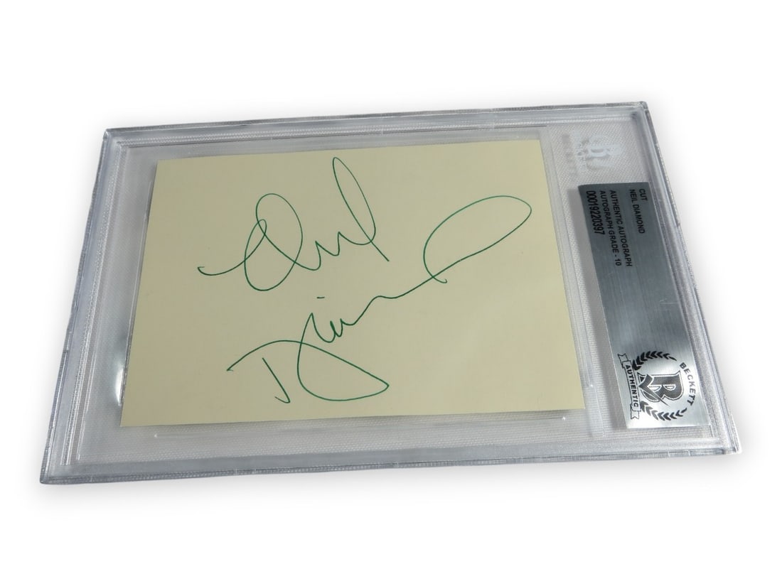 Beckett Authenticated Neil Diamond Autograph Cut Signature Encapsulated: Beckett Authenticated Neil Diamond Autograph Cut Signature Encapsulated This is an original cut signature card autographed by rock legend Neil Diamond. The autograph has been professionally authentica