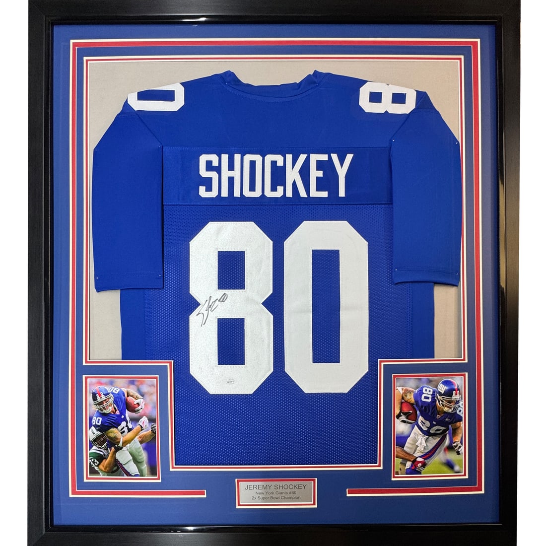 Framed Jeremy Shockey signed New York Giants jersey JSA COA 33x42: Framed Jeremy Shockey signed New York Giants jersey JSA COA 33x42 This professionally framed and matted New York Giants blue jersey is autographed by Jeremy Shockey. The display includes two 8x10 phot