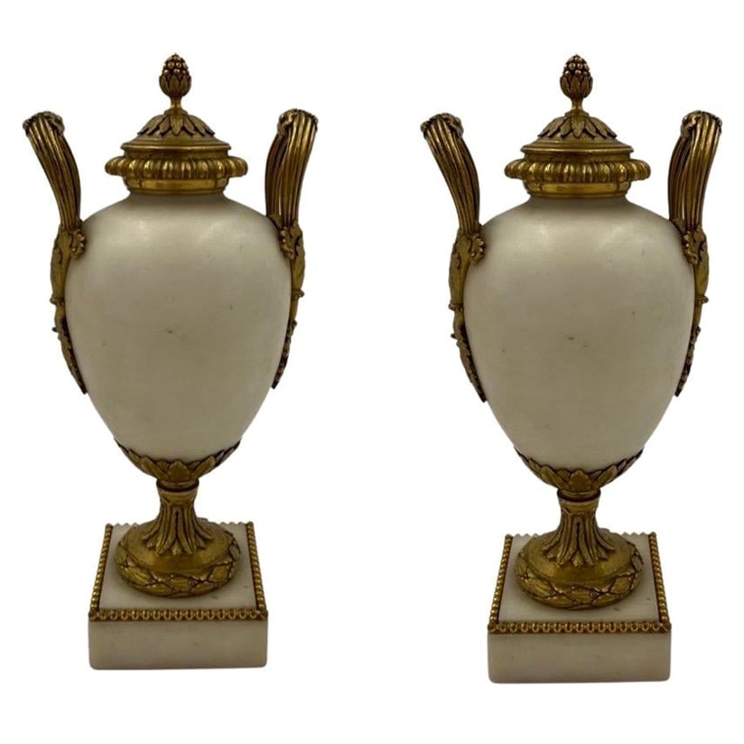 19th Century French White Marble Bronze Ormolu Vases Set of 2: 19th Century French White Marble Bronze Ormolu Vases Set of 2 This exquisite pair of 19th-century French vases showcases the beauty of white Carrara marble, elegantly complemented by gilt bronze ormol